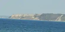 The dramatic southern coast. The yellowish rather than white colour of the cliffs indicates more sand than chalk.