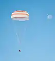 The Soyuz TMA-21 capsule descends toward landing.