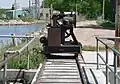 Rail-mounted winch atop diversion dam