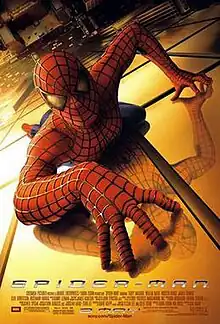 Spider-Man in his suit crawling over a building and looking towards the viewer. Below of him is New York City, the film's title, credits, and release date.