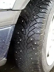 Nokian tyre with round metal studs, spike like protrusions to increase traction in ice