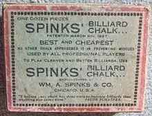 Image: A faded white cardboard box, about 3 by 4 by 1 inches, with a red border and black text, reading "One dozen pieces SPINKS' BILLIARD CHALK" and various promotional slogans such as "BEST and CHEAPEST", and "USED BY ALL PROFESSIONAL PLAYERS", among other lines, some indistinct.