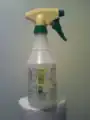 A bottle with a hand-pumped sprayer