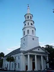 St. Michael's church, a white historic church building, is shown on a clear day