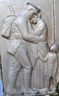 Relief on the St Annes on Sea War Memorial.  A soldier says farewell to his wife and child.