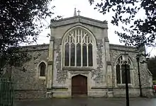 Very large arched window above a large wooden door