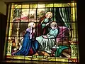 Close up of one of the stain glass windows, where St Joseph lies with Jesus and Mary.