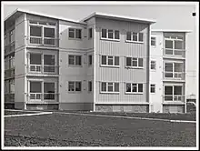 Photograph of three-storey apartment block.