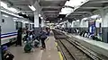 The south platform of the station filled with Greater Bandung Commuter Line passengers