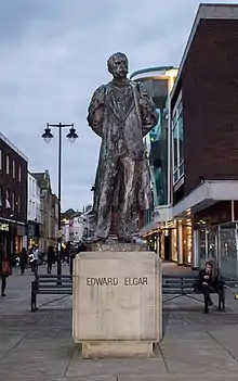 outdoor statue of man in lounge suit and academic gown