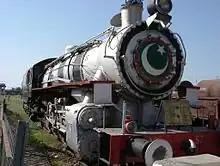 Grey steam engine on a siding