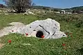 Upturned stone covering of well