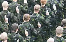 Finnish conscripts and women serving voluntary military service swearing their military oath in 2005