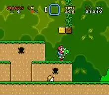 This screenshot shows Mario riding Yoshi during the first level of the game. The scenery shows a jungle environment with floating blocks scattered in the air. The interface displayed around the corners shows the number of lives the player has, the Dragon Coins collected, the player's stored power-up, the level's remaining time, the player's number of coins, and the total score of the player.