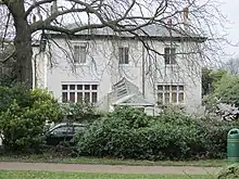 Early Victorian house seen from a park.