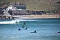 Surfers in sea at Sennen