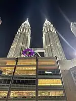 Exterior of the KLCC illuminated at night.