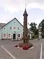 A roofed pole in the Švėkšna town center