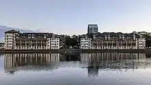 Two large residential buildings facing onto a dock