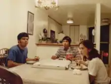 A photo of band members Roby, Viet and Val eating pizza.