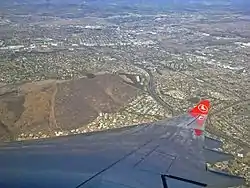 An aerial view of the Tygerberg hills and the suburbs of Panorama and Welgemoed surrounding the hill, with the N1 highway being clearly visible in this photograph.