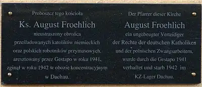 Bilingual commemorative plaque in memorial of Priester August Froehlich in front of St Paul's church in Drawsko Pomorskie.