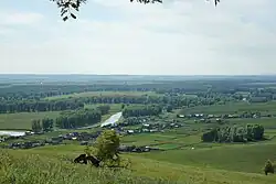 small village in vast green landscape