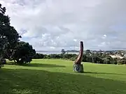 Takaparawha Pou (pole or column) installed at Takaparawhau (Bastion Point) in 2019, designed by Lenard Philips and Te Aroha Witika. The pou has the shape of a taurapa (the stern of a waka) standing on a concrete plinth representing the toka (rock) that acted as a beacon for waka, known as Bastion Rock.