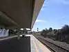 A railroad station platform with an overhead canopy