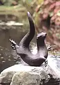 Bronze otter sculpture by Laurence Broderick in the gardens of Armadale Castle