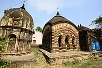 The three temples of Ghosalpara at Patrasayer in Bankura district of West Bengal. The temple on the left is a pancharatna deal Shiva Temple; the middle one is a charchala Raghuvir Temple while the temple on the extreme right is a dalan temple dedicated to Goddess Kali. All the temples are built of laterite.