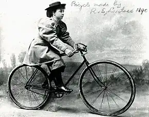 1800s photo of a woman on a man's bicycle