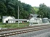 Waiting room, bicycle rack and underpass next to the station building