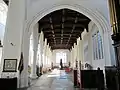 Thaxted Church, North Aisle with the covered font in the distance.