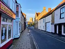 View of the Causeway, a narrow street in Bicester, showing historic buildings on either side.