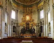 Pews before the ornate, gold-leafed throne of St. Peter