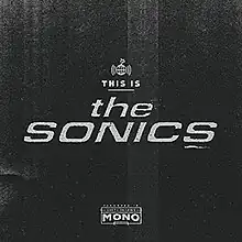 A black cover with grey text for the album name and artist