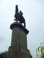 statue of an individual seated in a horse