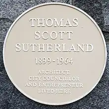 A circular commemorative plaque bearing the inscription 'Thomas Scott Sutherland 1899 – 1964 Architect, City Councillor and Entrepreneur lived here.'