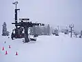 Bunny slope with chairlift. The top and the bottom are both visible as well as the wide, gentle slope.