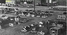 Tiny Town blocks, with a "For Sale" sign in the background