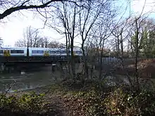 The Medway flows through Tonbridge in many channels. The South Eastern Main Line crosses the Medway.