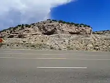 Road cut in Puye Formation, showing gravel beds of the Totavi Lentil near its type section.