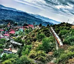 Totu suburb view from uphill with a passing train