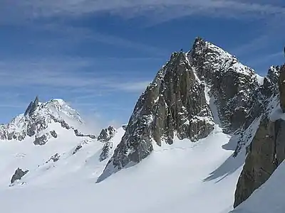 West face of Tour Ronde showing Gervasutti Couloir and the smaller Rebuffat Couloir to its left. The Dent du Géant  is clearly visible in the distance.