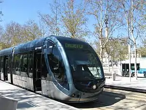 Blue-and-silver tram at side platform