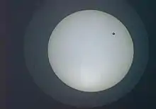 2004 transit as seen from Bangalore at 07:41 UTC, about two hours into the transit. The image is inverted compared to the diagram above, so Venus is seen near the top of the Sun's disc