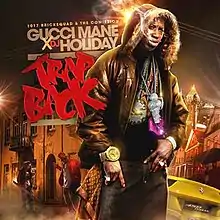 Gucci Mane stands in a distorted nighttime cityscape of Atlanta, looking at the camera/viewer, with a fur-covered hood over his head. Wisps of smoke (or perhaps mist) billow from his mouth. He is wearing a lot of ostentatious jewelry: a large gold watch, rings, numerous necklaces. One of the necklaces has a jewel-encrusted pendant in the shape of an ice cream cone, and the same ice cream cone is seen tattooed on Gucci Mane's face. Two other men and a yellow Ferrari 458 are seen behind Gucci Mane.