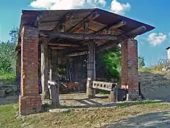 Roofed ox shoeing crush of three-column construction in Pievasciata, Castelnuovo Berardenga, Siena, Italy