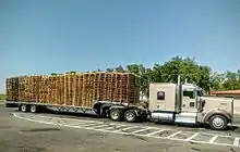 An eighteen-wheeler carrying used wooden pallets